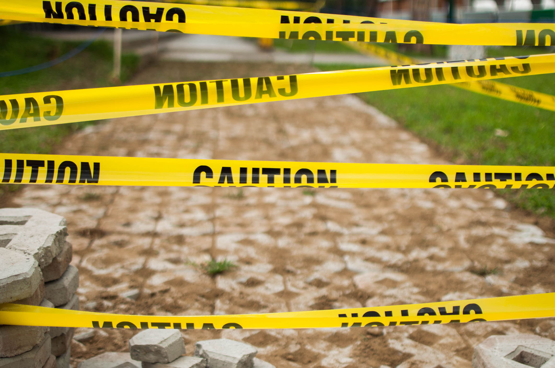 A close-up view of yellow tape caution sign.